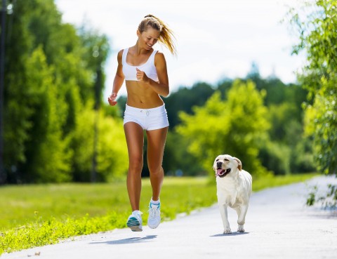 A Picture Showing A Woman Doing Jogging With Her Dog